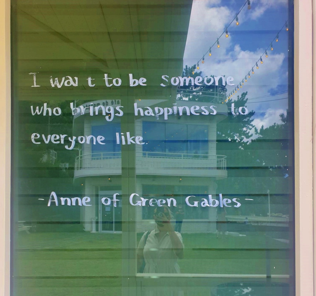 A picture of a cafe window with the phrase I want to be someone who brings happiness to everyone like...
The quote is attributed to Anne of Green Gables